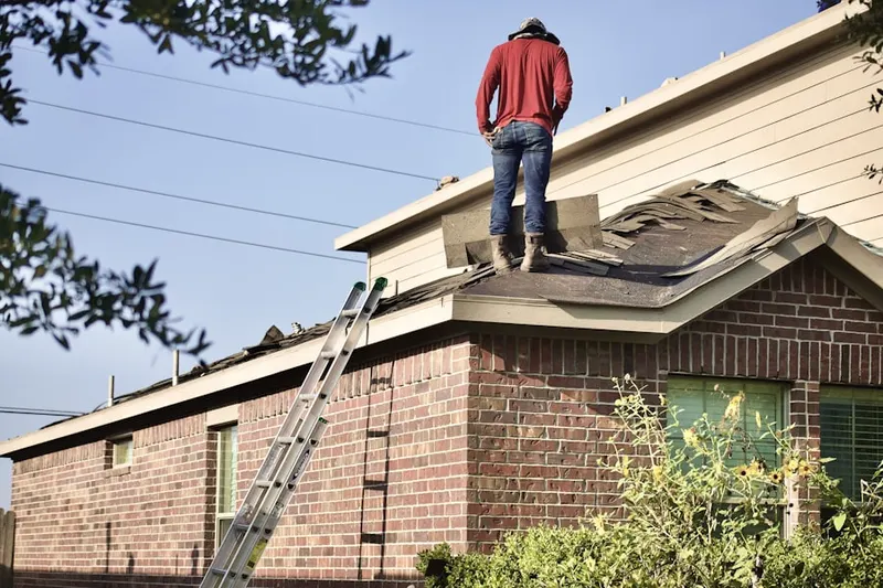 Professional roofer working on a residential roof in Leawood North